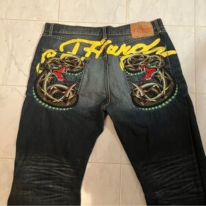 Ed Hardy blue denim jeans.  Embroidery on pockets.  Wear on heel.